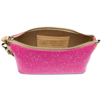 Small berry-colored Midtown Crossbody purse with pink speckled glitter, brown interior, and a leather patch inside reading “MAKE TODAY RIDICULOUSLY AWESOME!”. Available in one size.