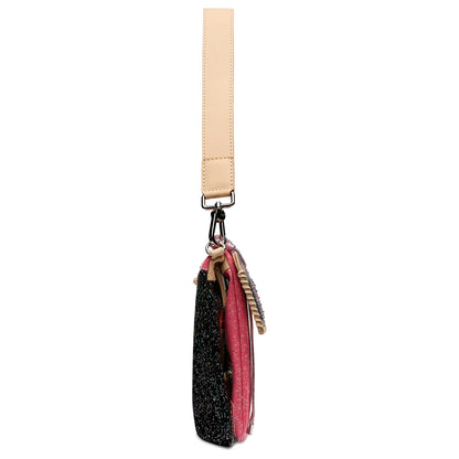 A side view of the small Metro Crossbody in available sizes, featuring a beige handle, black and pink textured sections, decorative accents, and a clip attached to the handle; it converts from crossbody to wristlet.