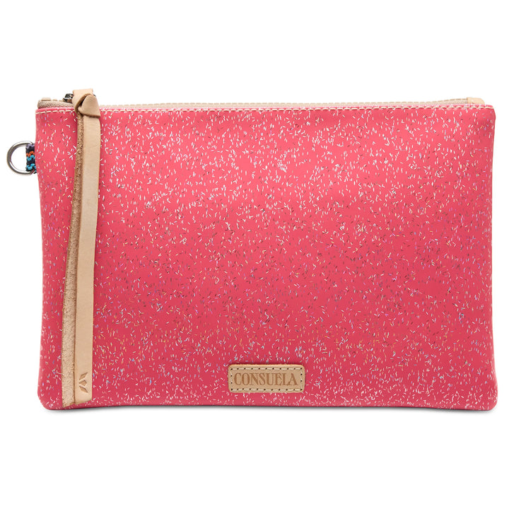 Bright pink pouch with speckled pattern, beige leather zipper strap, and gold Consuela label on front. Sizes available: Mighty.