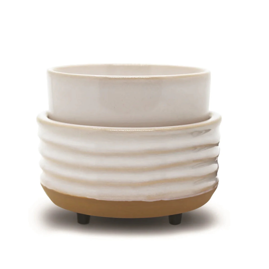 The Candle &amp; Wax Warmers Set features a white ceramic planter with a ribbed texture on a tan base, accented by small black feet for modern elegance.