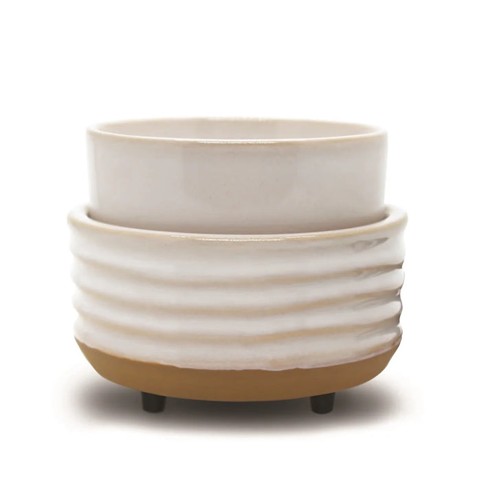 The Candle &amp; Wax Warmers Set features a white ceramic planter with a ribbed texture on a tan base, accented by small black feet for modern elegance.