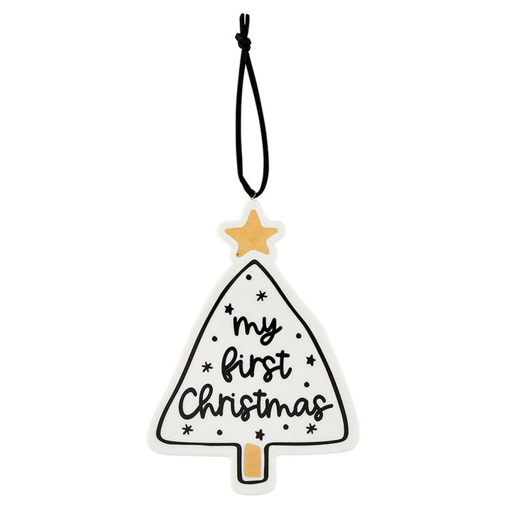 Christmas tree ornament with gold star and “my first Christmas” lettering on a black cord.