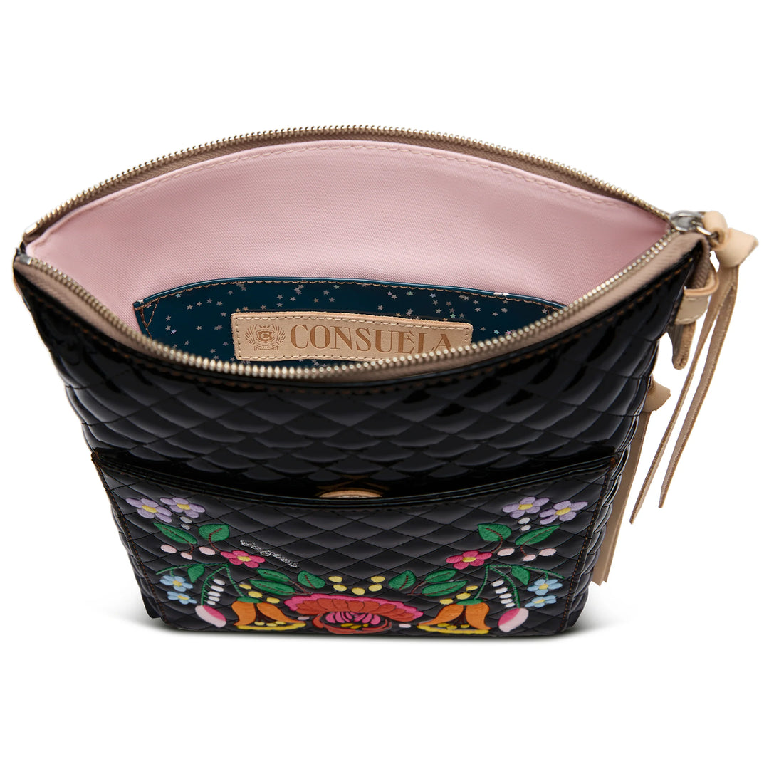 Black quilted crossbody with colorful floral embroidery, beige zipper, pink lining, interior "Consuela" label. Sizes: S/M/L.