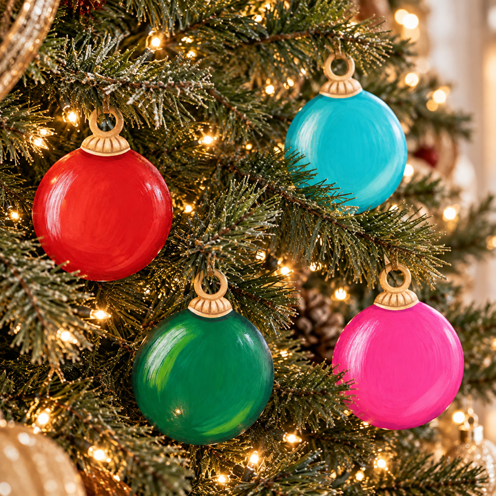 Four round tree ornament magnets in red, teal, green, and pink with a smooth finish.