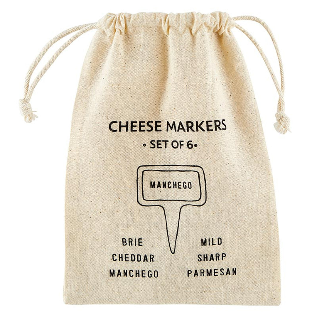A set of 6 ceramic cheese markers in a beige drawstring bag with black text featuring cheese names like Brie, Cheddar, and Manchego. Ideal for labeling cheeses at parties. Sizes: N/A.
