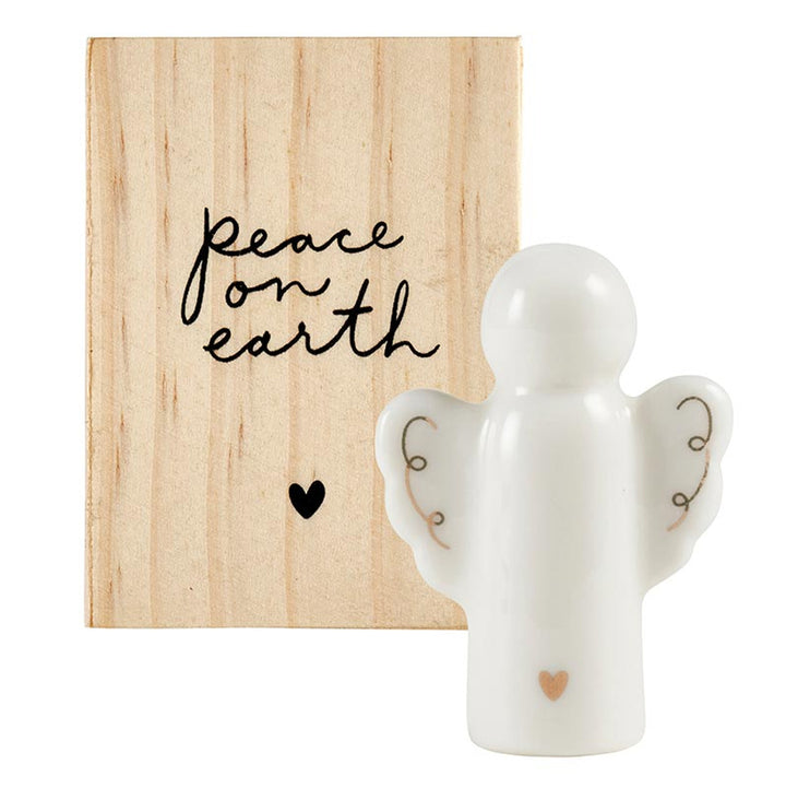 White ceramic angel figurine with a small heart.