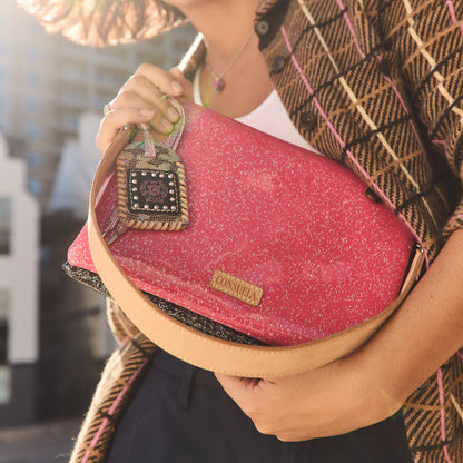 Consuela Metro Crossbody, Bae: pink handbag with tan strap and patterned keychain, convertible to a wristlet. Available in small and medium sizes.