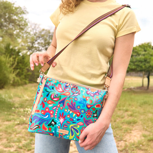 Downtown Crossbody, Tasha features vibrant floral and abstract designs on signature ConsuelaCloth with an adjustable strap. Available sizes: small, medium, large.