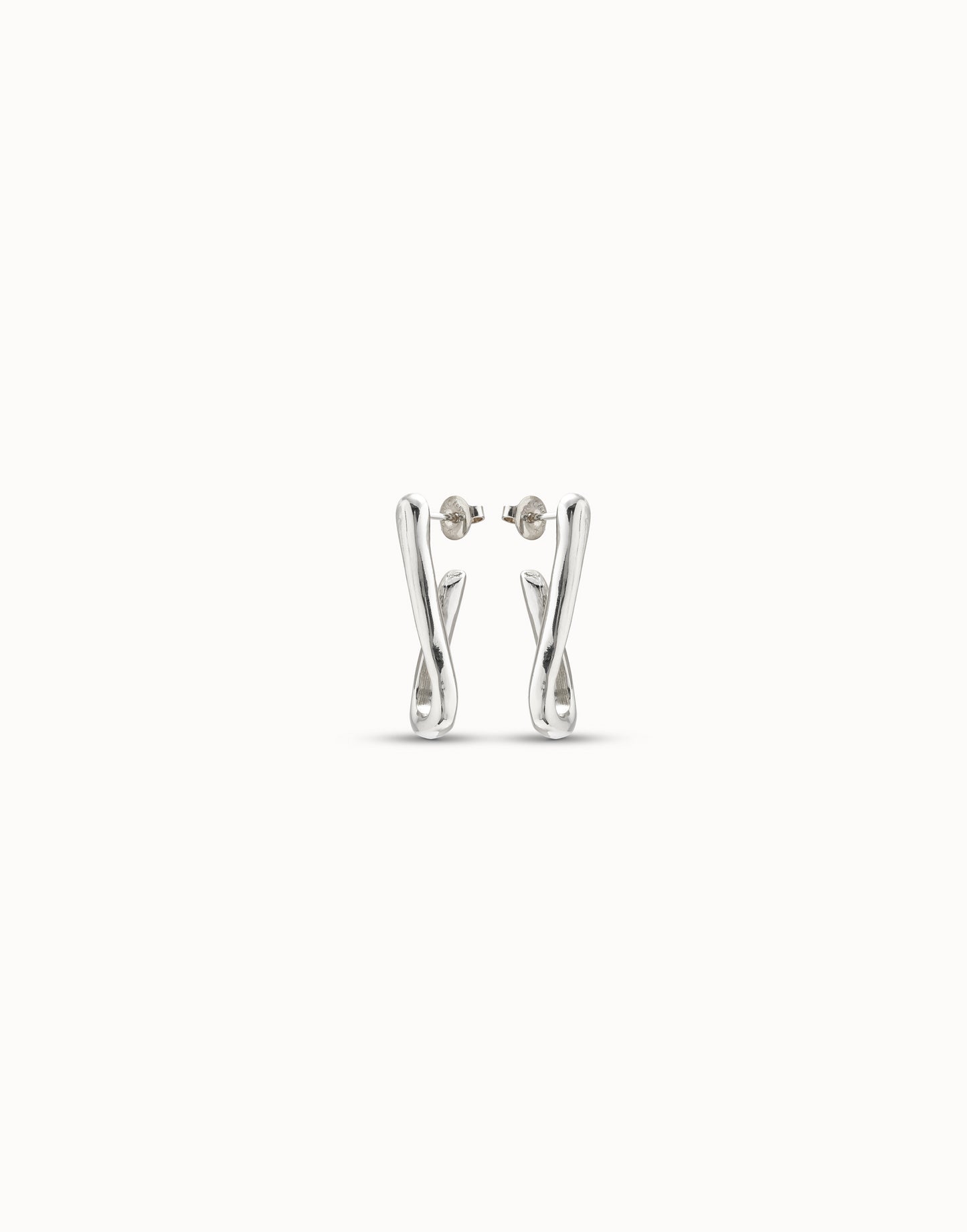 Silver link-shaped hoop earrings in handcrafted sterling silver with abstract twisted loops. Available sizes: small, medium, large.