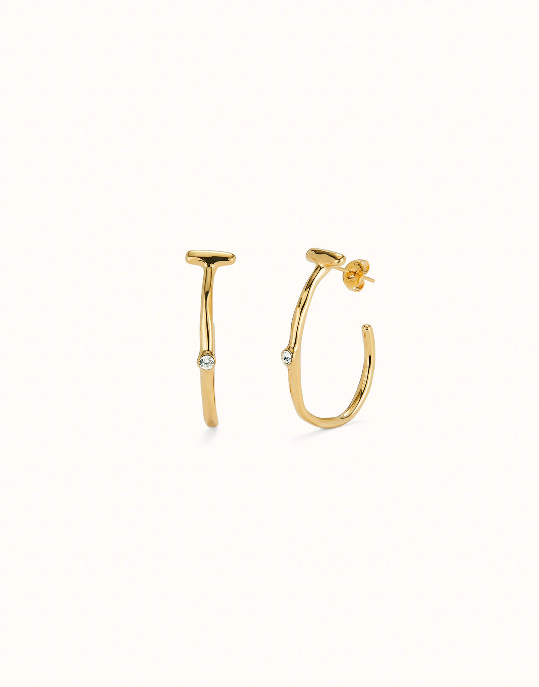 Hoop earrings with white topaz, crafted in 18K gold-plated metal with a modern design. Each earring has a small round white topaz gemstone at the center. Available sizes: small, medium, and large.