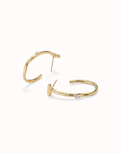 18K gold-plated open hoop earrings with a small, round white topaz gemstone set into each. Available in multiple sizes.