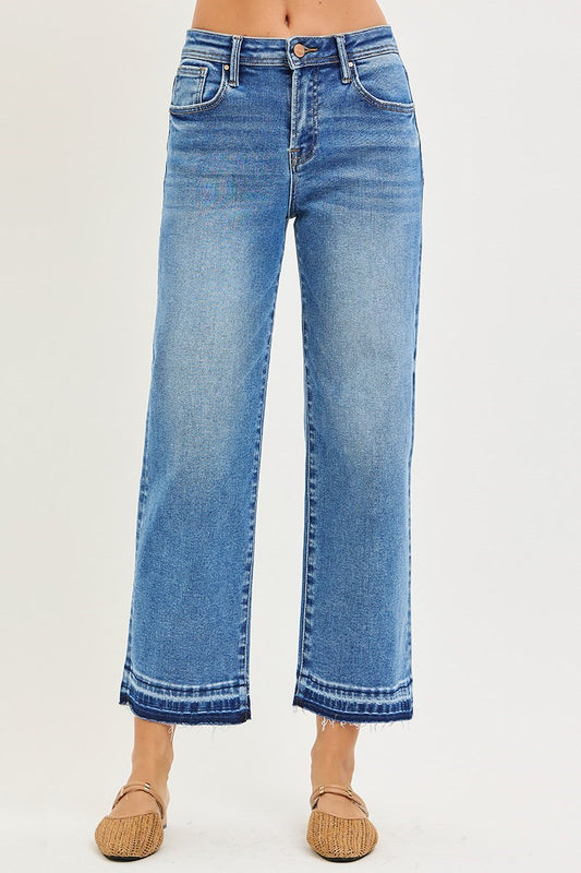 Risen Medium Wash Cropped Boyfriend Jeans: high-waisted, light blue, wide-leg, frayed hems. Available in sizes 24-32.