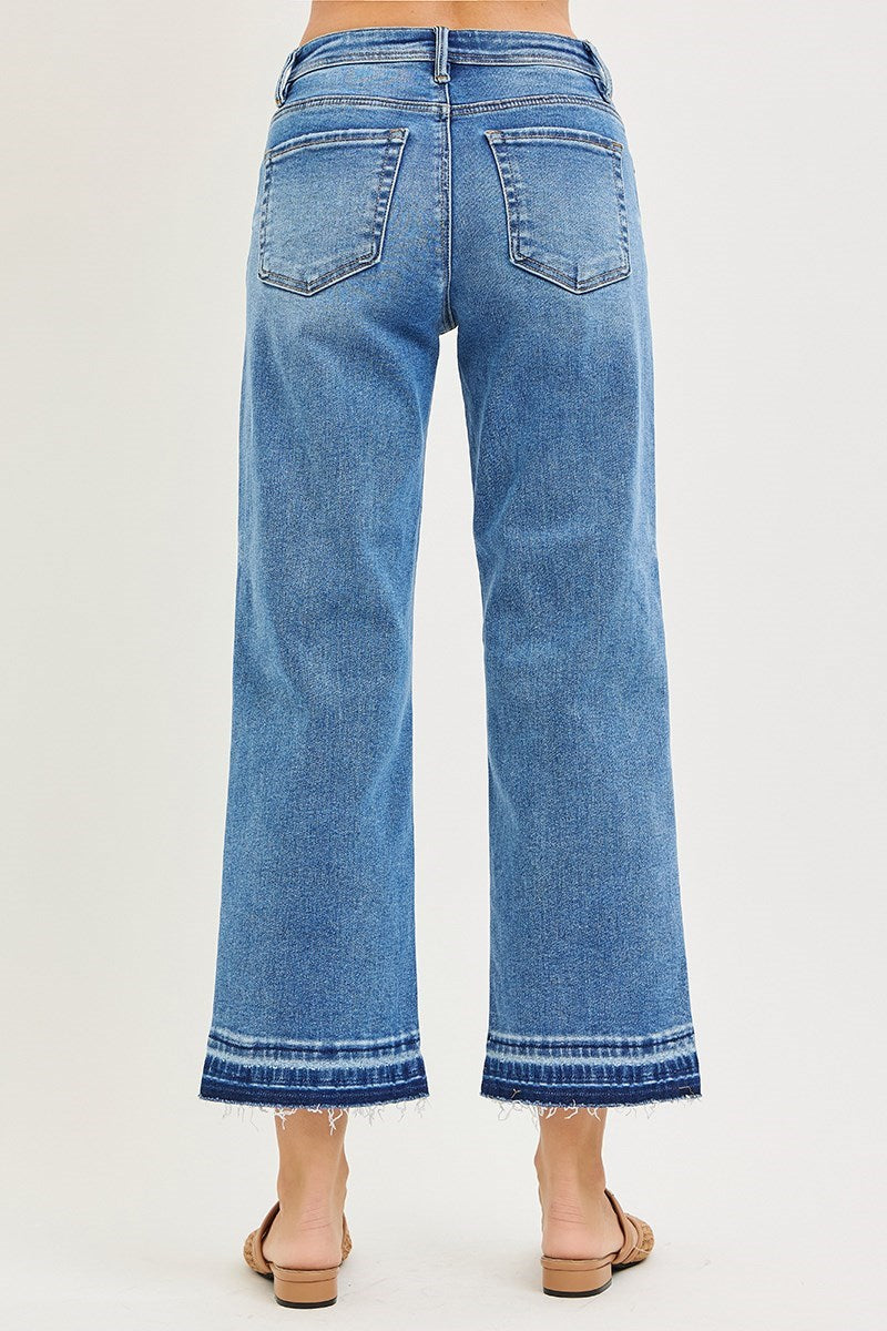 Risen Medium Wash Cropped Boyfriend Jeans with high waist, wide legs, frayed hems, rear pockets. Sizes S-XL. Back view.