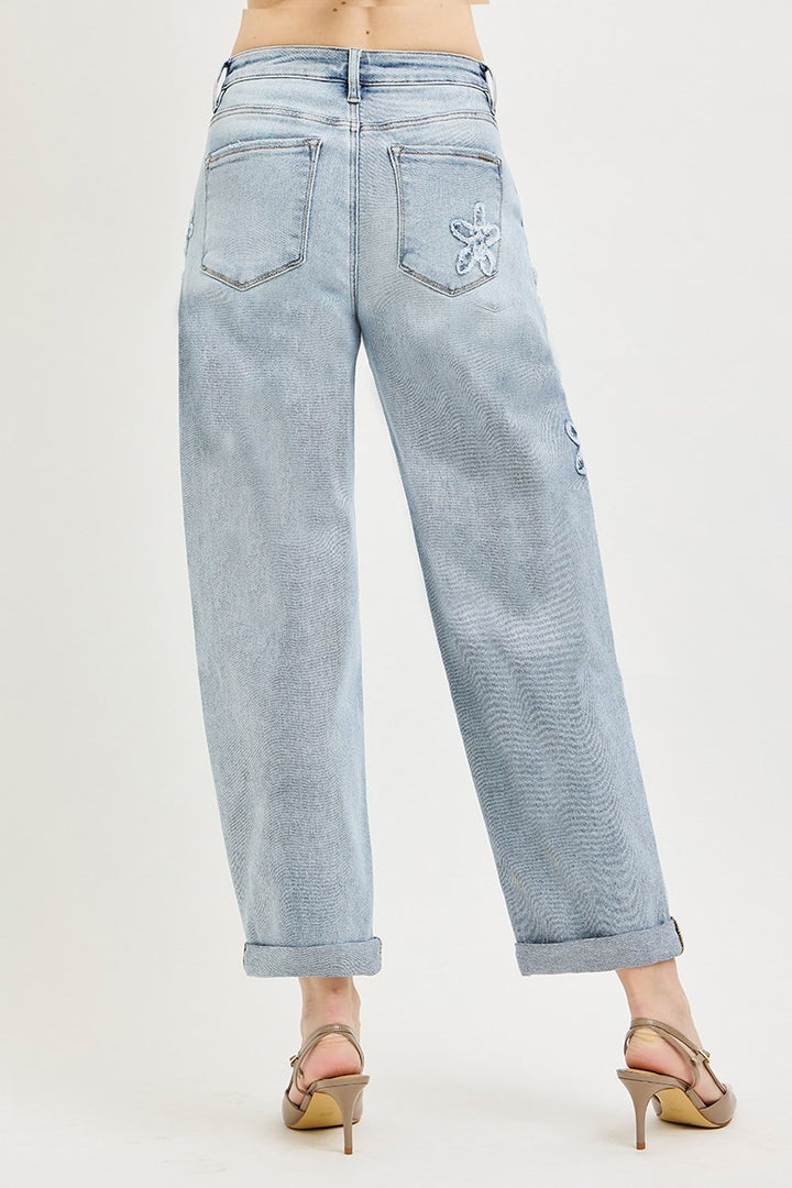 Risen Flower Patch Crop Barrel Jeans with embroidered details and adjustable cuffs. Available in sizes 24-32.