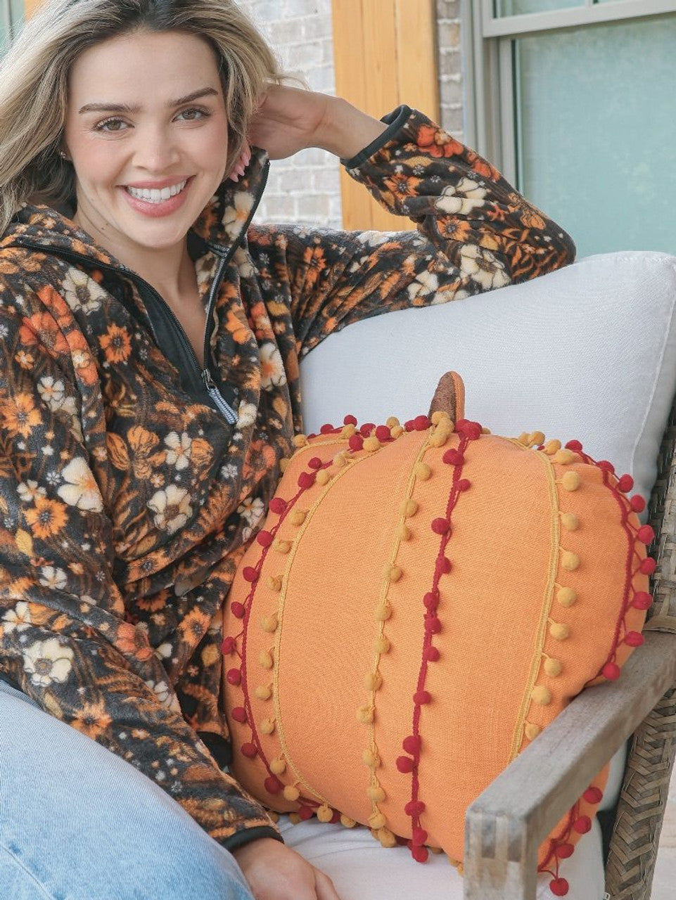 **Pumpkin Pom Pom Pillow:** Orange holiday pillow adorned with red and yellow pom-poms. Available sizes: 18x18 inches, 20x20 inches, 22x22 inches.