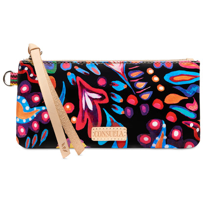 The Pop Pouch, Sophie is a Consuela clutch with bold abstract floral patterns in red, blue, orange, and pink on black. Features include a tan leather zipper pull, woven side detail, and keyring attachment. Available sizes: [sizes not specified].
