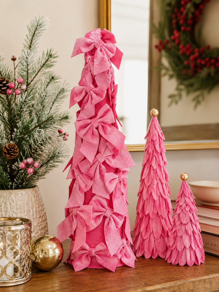 Three conical Velvet Decor Tree fabric petal Christmas trees in pink with bows and fringe, in small, medium, and large sizes.