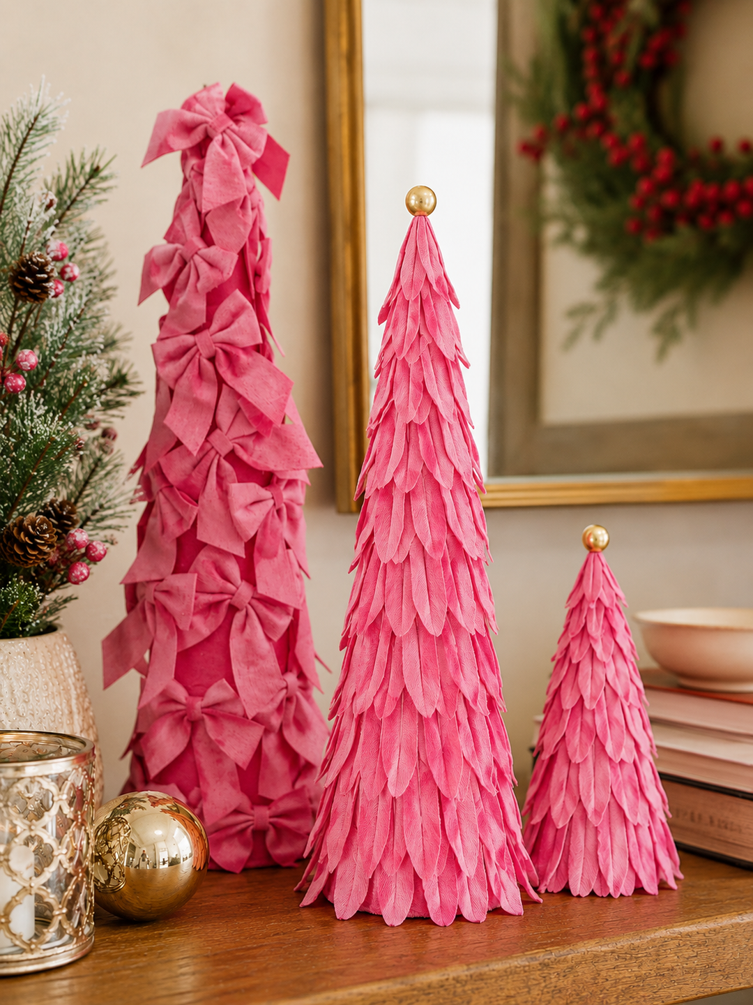 Three pink Velvet Decor Trees: one tall tree with bows and two smaller trees with layered fabric petals, each with a gold sphere topper.