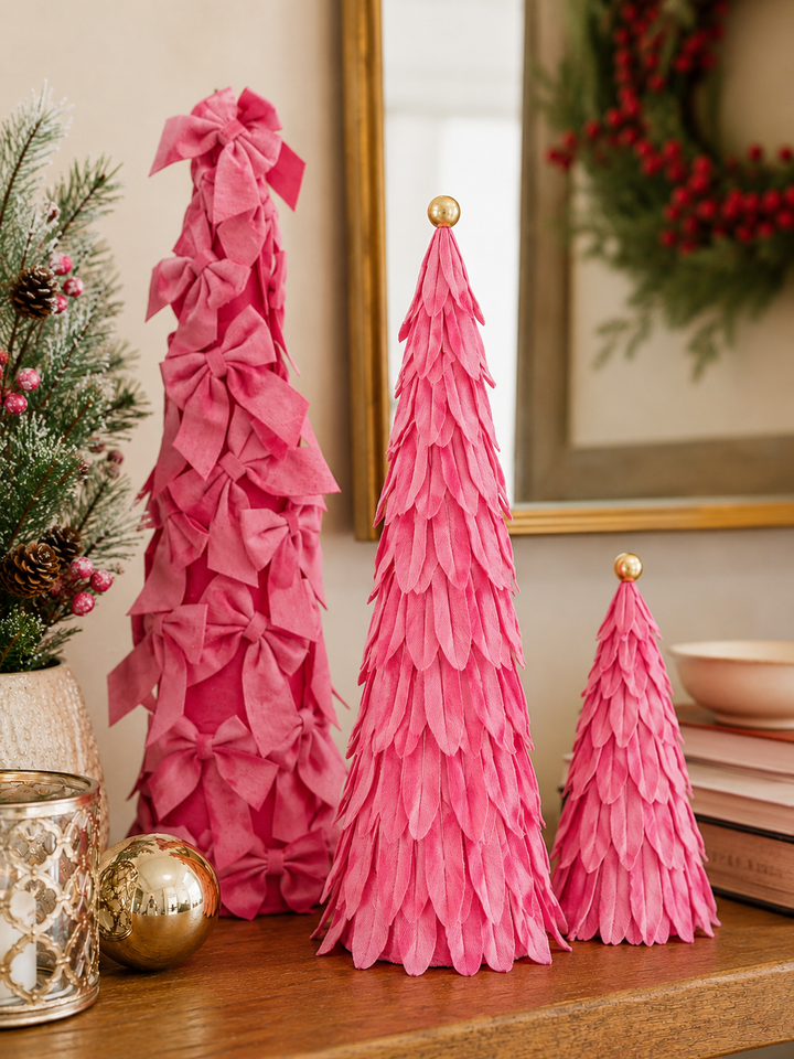 Three pink Velvet Decor Trees: one tall tree with bows and two smaller trees with layered fabric petals, each with a gold sphere topper.