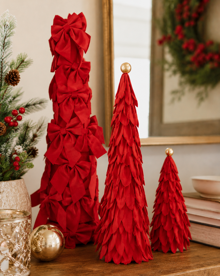 Three Velvet Decor trees in varying sizes: one with red bows and two with red petals, each with a gold sphere topper.