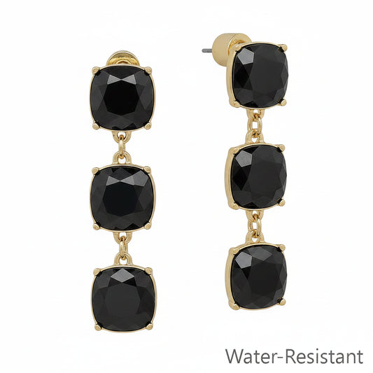 Pryn Black Diamond Post Earrings with gold drop dangles and three linked square black gemstones. Water-resistant. Sizes available: small, medium, large.