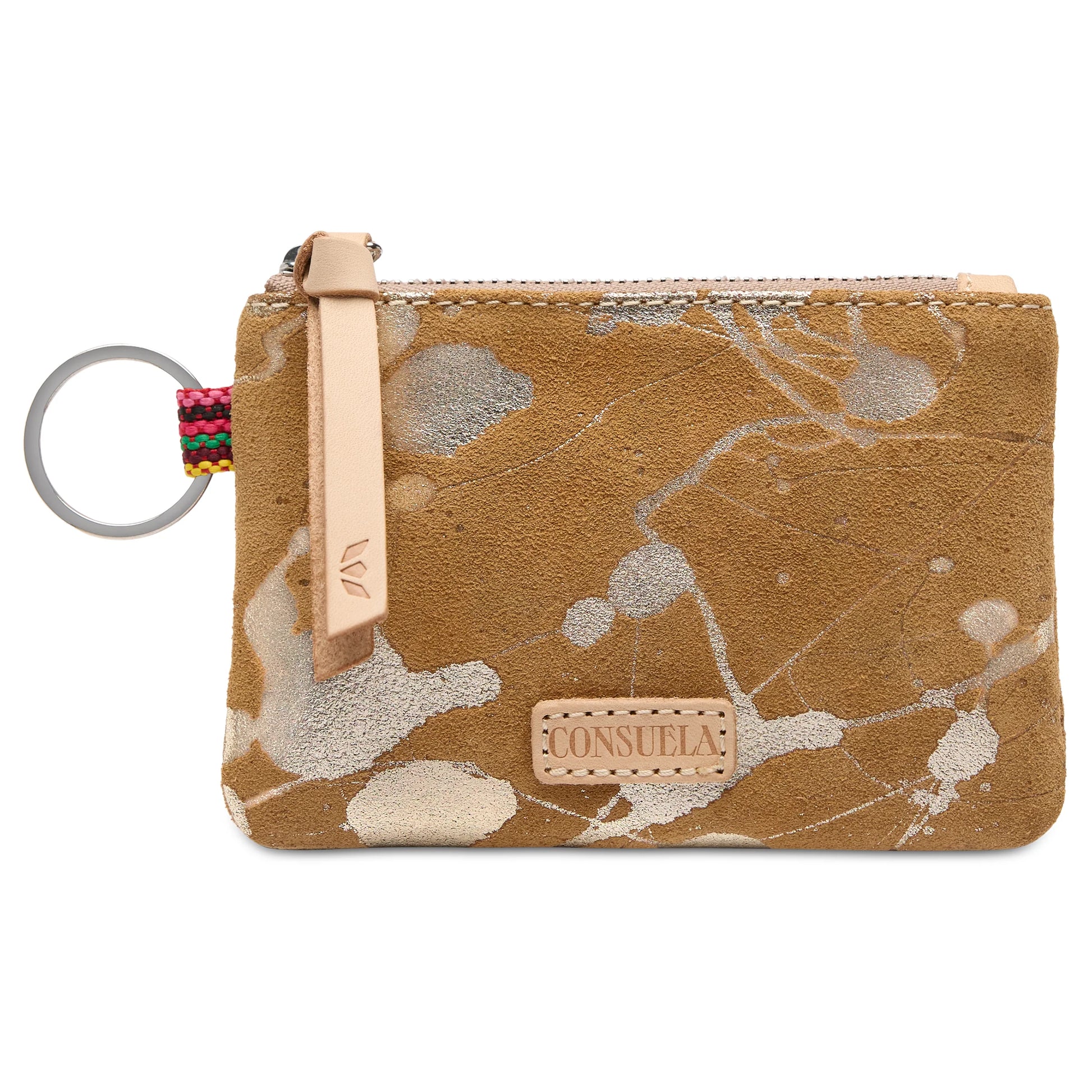 Marlow Pouch: Small tan suede wallet with light paint splatters, leather zipper pull, multicolored fabric accent, silver keyring, and front “CONSUELO” patch. Compact card organizer. Size availability not specified.