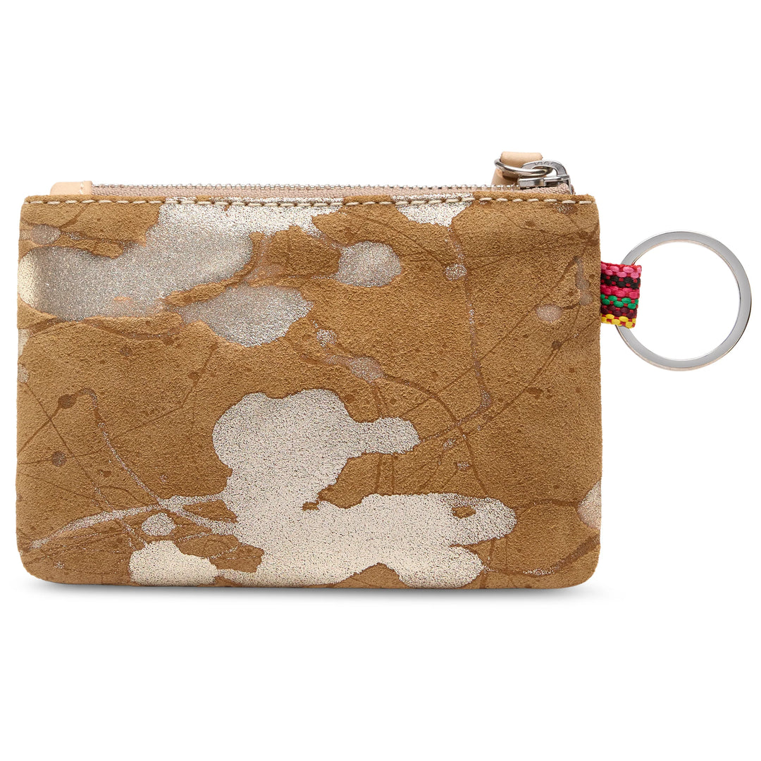 Small tan suede zippered coin pouch with white splotches, silver zipper, silver keyring, and a multicolored woven loop near the zipper. Fits coins or cards. Available in one size.