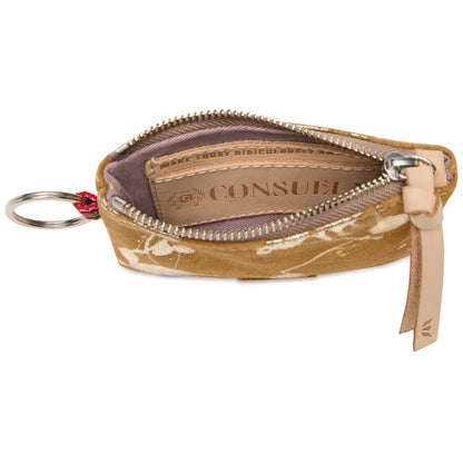The Pouch, Marlow is a small tan suede wallet with white embroidery, an unzipped compartment showing a leather Consuela tag inside, a leather keyring on the left, and a leather zipper pull on the right. Available in one compact size.