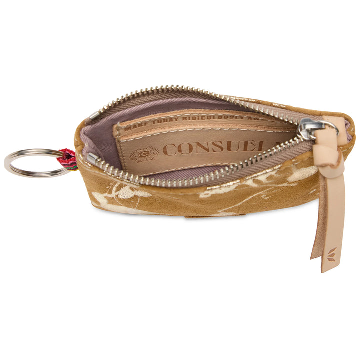 The Pouch, Marlow is a small tan suede wallet with white embroidery, an unzipped compartment showing a leather Consuela tag inside, a leather keyring on the left, and a leather zipper pull on the right. Available in one compact size.