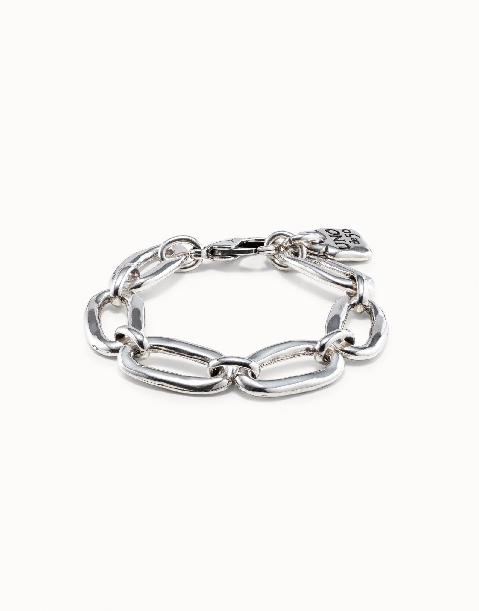 Sterling silver chunky link bracelet with large oval-shaped links and a small flat charm near the clasp, handmade in Spain. Available sizes: S, M, L.