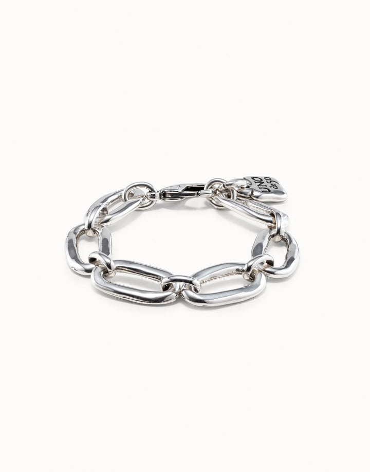 Sterling silver chunky link bracelet with large oval-shaped links and a small flat charm near the clasp, handmade in Spain. Available sizes: S, M, L.