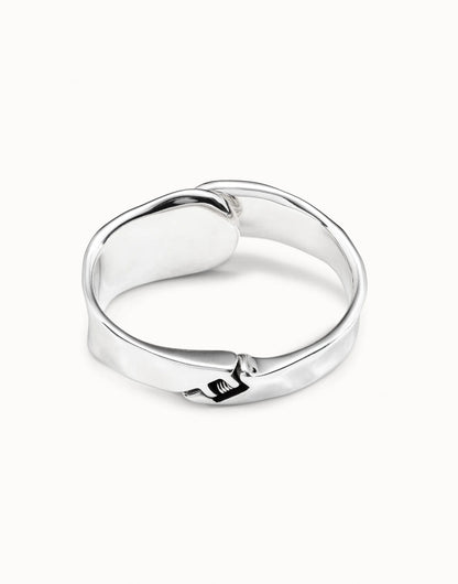 Minimalist polished silver bangle bracelet, handcrafted in Spain with a wrapped belt and small buckle detail at the front. Available in S, M, and L sizes.