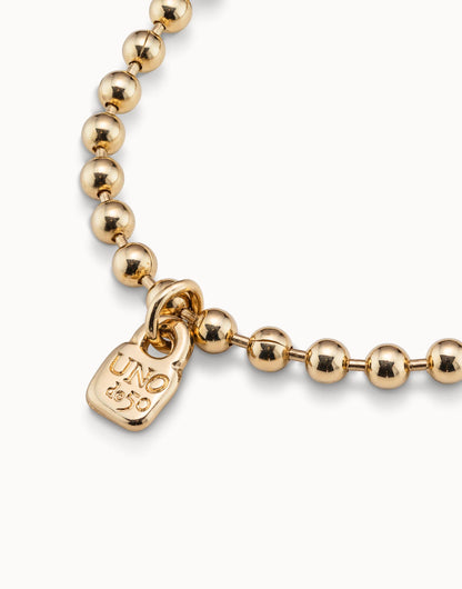Gold-plated Beaded Charm Bracelet, handmade in Spain, with a small gold "UNOde50" engraved charm; available sizes: S, M, L.