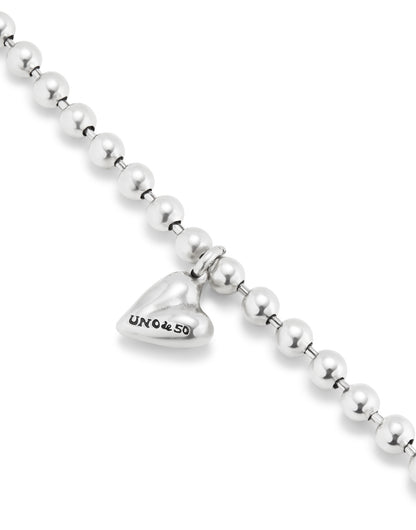 Beaded Bracelet with Heart Charm: features a heart-shaped charm engraved with "UNOde50" on a strand of round sterling silver beads. Available in multiple sizes.