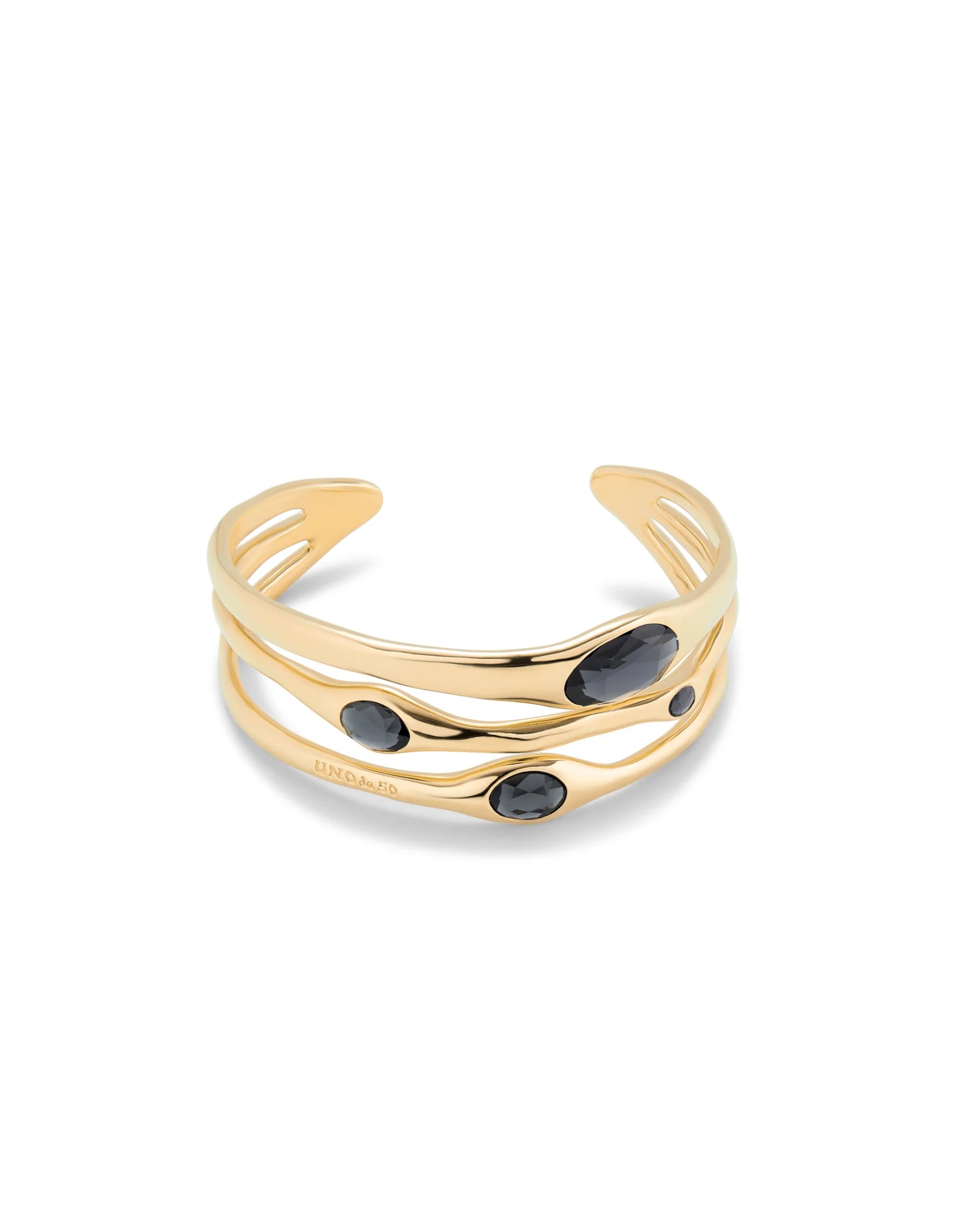 Bangle bracelet with three wavy, overlapping 18k gold bands, accented by three oval black gemstones and crystals. Available in sizes S, M, and L.