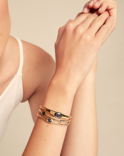 Bangle Bracelet with Crystals in 18k gold, set with dark faceted crystals; available in sizes S, M, and L.