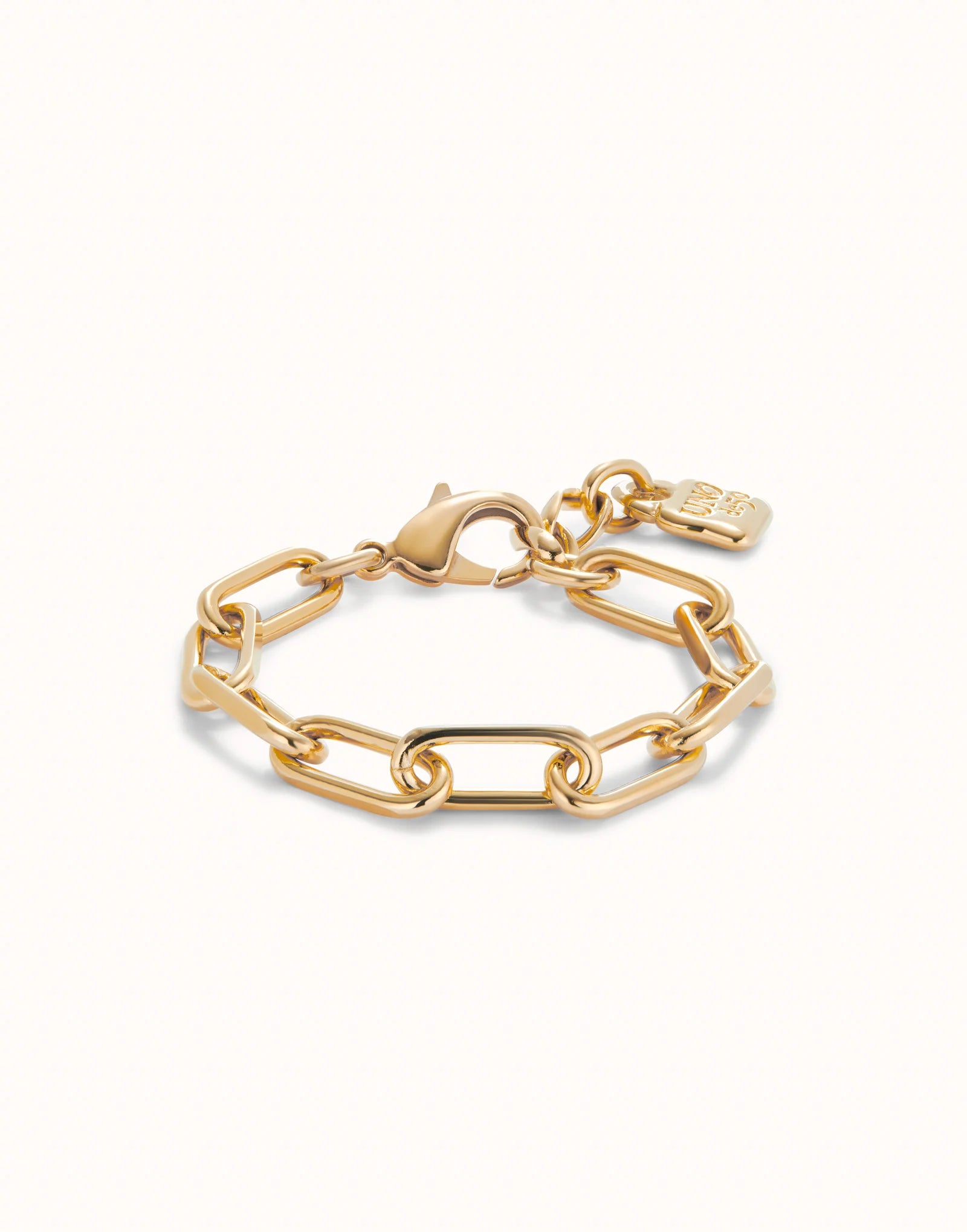 Gold Paper Clip Link Bracelet with Padlock features large rectangular links, a lobster clasp, and a small engraved tag. 18K gold-plated, handmade; available in 6", 7", and 8" sizes.