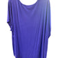 Loose-fitting, short-sleeved purple tunic with wide neckline and relaxed drape. Available in sizes XS-XXL.