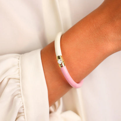 Pink & Ivory Yin & Yang All Weather Bangle®: half white, half pink with gold accent, clear gemstone. Available in S, M, L.