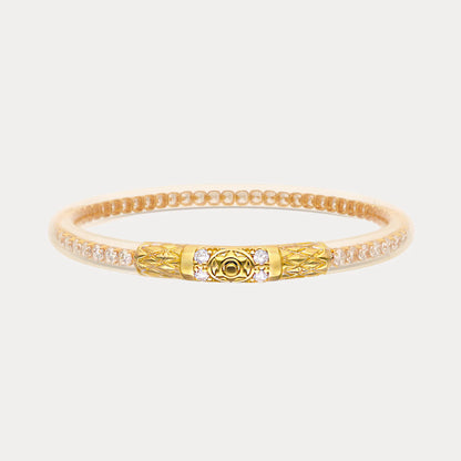 Handcrafted gold bangle with clear crystals and a textured, patterned clasp. Available in S, M, L sizes.
