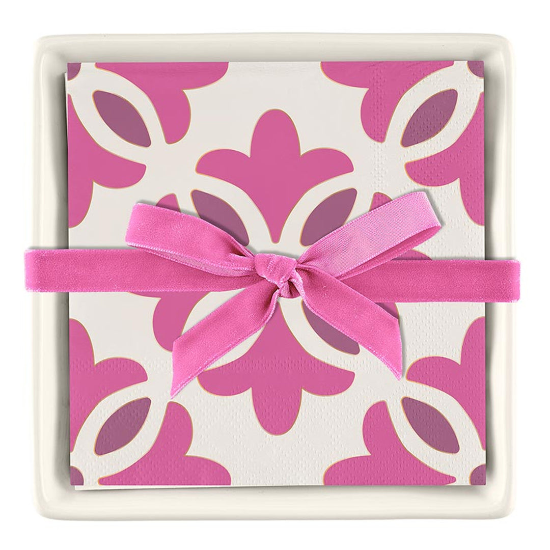 Ceramic Napkin Tray + Napkins Set: Includes a tray with paper cocktail napkins in a pink and white floral pattern, tied with a pink ribbon. Sizes available may vary based on the retailer.