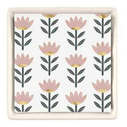 The Ceramic Napkin Tray + Napkins Set features a white napkin with pink and gold floral designs, complemented by green leaves. No specific sizes available.