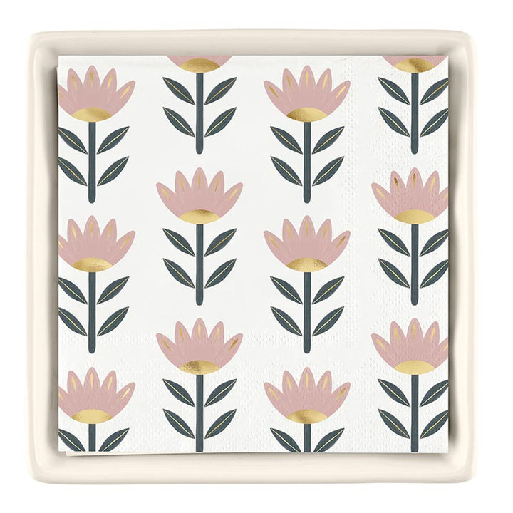 The Ceramic Napkin Tray + Napkins Set features a white napkin with pink and gold floral designs, complemented by green leaves. No specific sizes available.