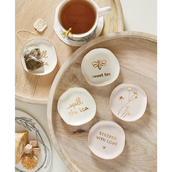 Ceramic Tea Bag Holders with floral and bee motifs, inscribed with "spill the tea," "sweet tea," and "steeped with love." Sizes available: Small, Medium, Large.