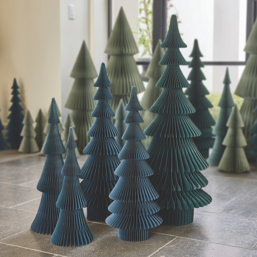 Navy blue honeycomb paper tree decorations in varying heights.