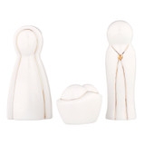 Minimalist wooden nativity figurines of the Holy Family (Mary, Joseph, and baby Jesus).