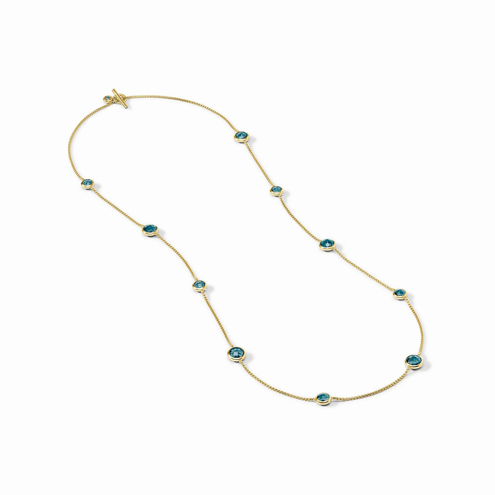 Gold chain necklace with evenly spaced round Montana blue gemstones in bezel settings. Available in 16", 18", and 20" sizes.