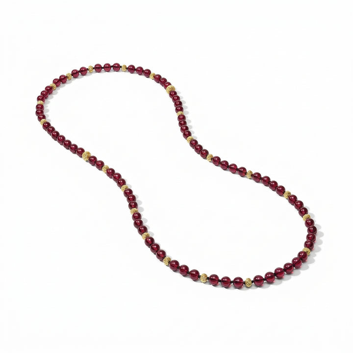 Ravello 5-in-1 Gold Necklace in cranberry, featuring cranberry beads with gold-plated textured spacers in an adjustable length design.
