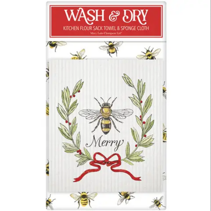Festive Christmas Wash &amp; Dry Set with a flour sack towel and sponge cloth featuring a bee and evergreen wreath illustration with a red ribbon and the text “Merry.”.