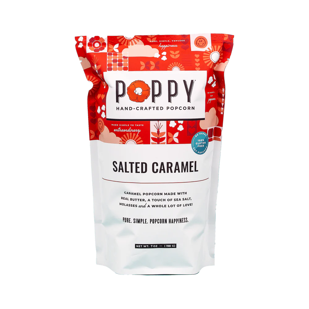 This hand-crafted Salted Caramel Poppy Popcorn is gluten-free and comes in a vibrant red and white packet. The packaging details the ingredients and features whimsical patterns.